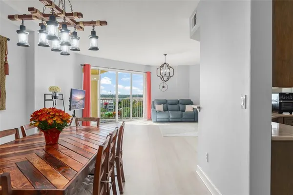 a view of a dining room with furniture wooden floor and chandelier