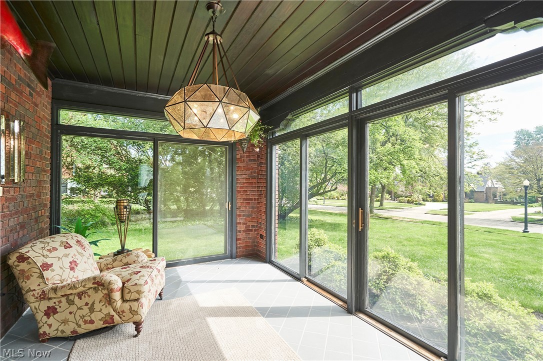 644 Ridgecrest Road Akron, OH 44303 - Photo 12 of 47 Sunroom featuring full-height windows, a wood-paneled ceiling, and exposed brick walls