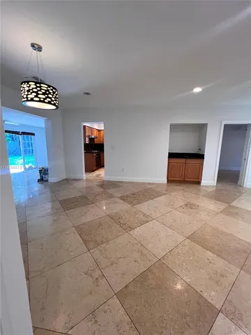 an empty room with windows and flowerpot