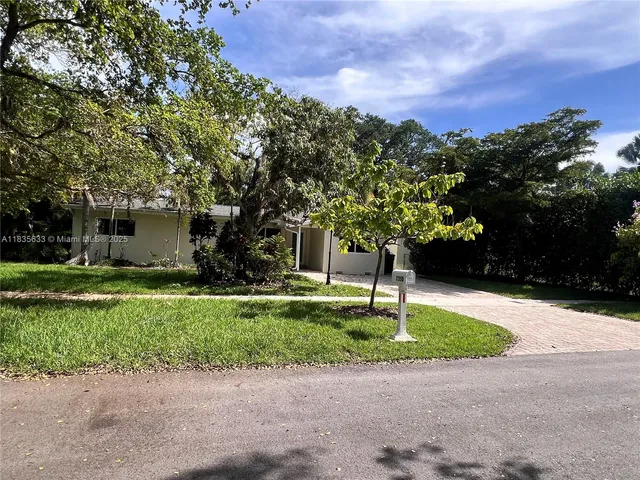 a front view of a house with a yard and a garage