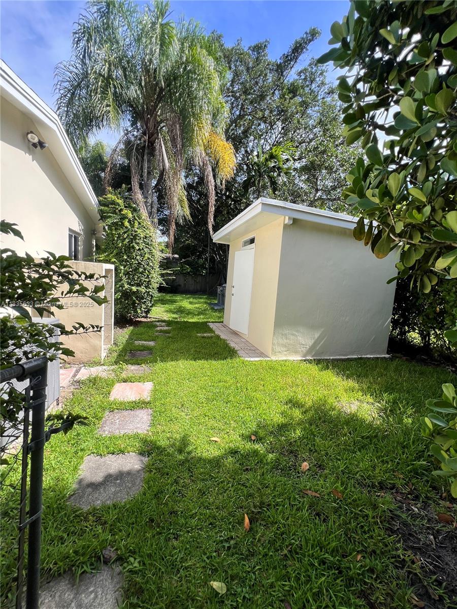 7350 Southwest 96th Street, Unit 7350 Pinecrest, FL 33156 - Photo 18 of 25 a view of a backyard