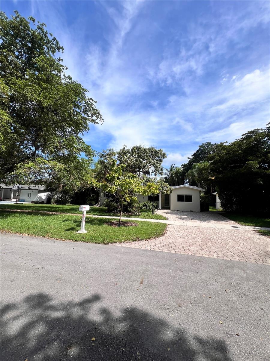 7350 Southwest 96th Street, Unit 7350 Pinecrest, FL 33156 - Photo 19 of 25 a view of street with a big yard and large trees