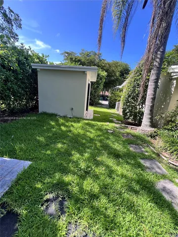 a view of a wooden house with a yard