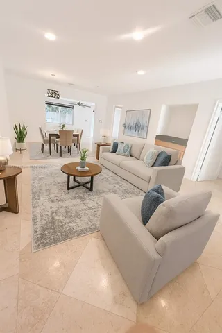 a living room with furniture and a potted plant