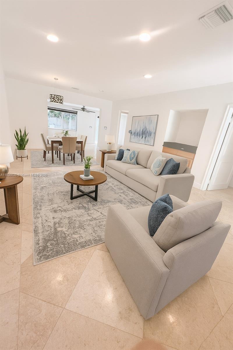 7350 Southwest 96th Street, Unit 7350 Pinecrest, FL 33156 - Photo 3 of 25 a living room with furniture and a potted plant