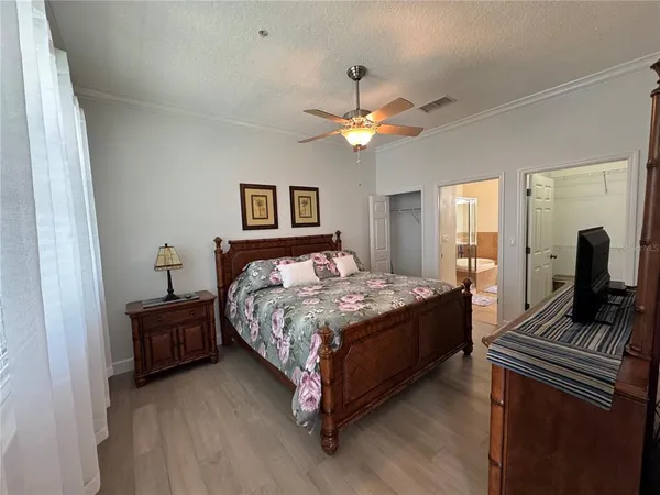 a bedroom with a bed dresser and a window
