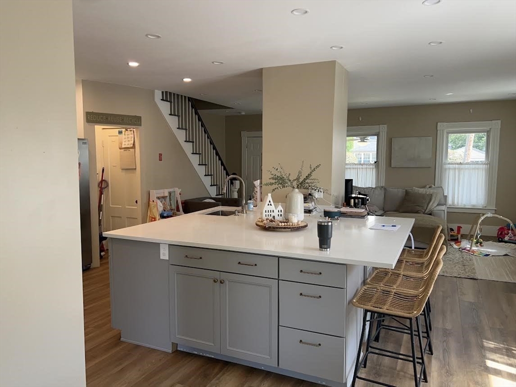 248 Greeley Street Clinton, MA 01510 - Photo 6 of 25 a room with a sink wooden floor and white cabinets