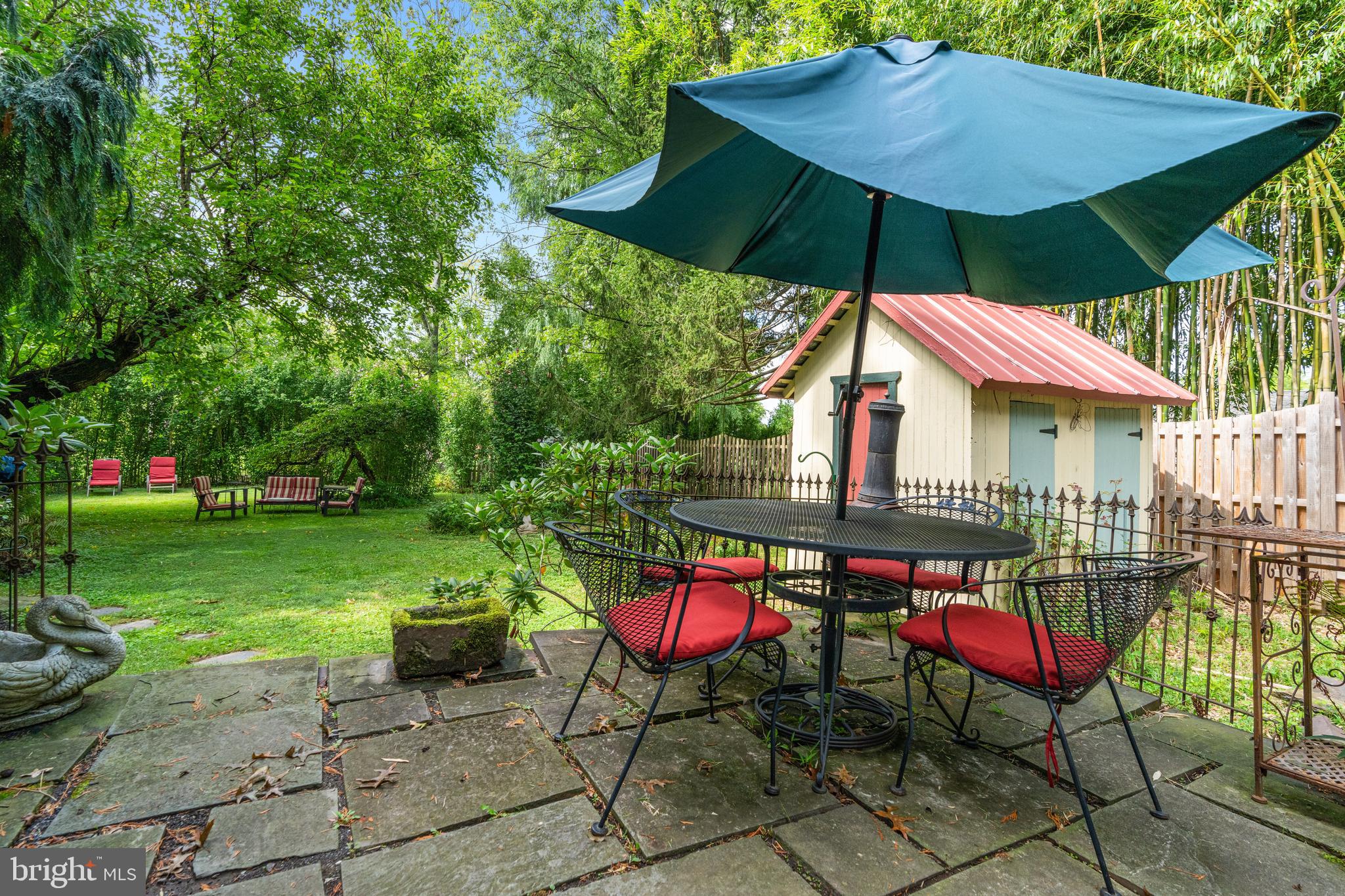 4140 Township Line Road Newtown, PA 18940 - Photo 12 of 41 a view of patio with chairs and table under an umbrella