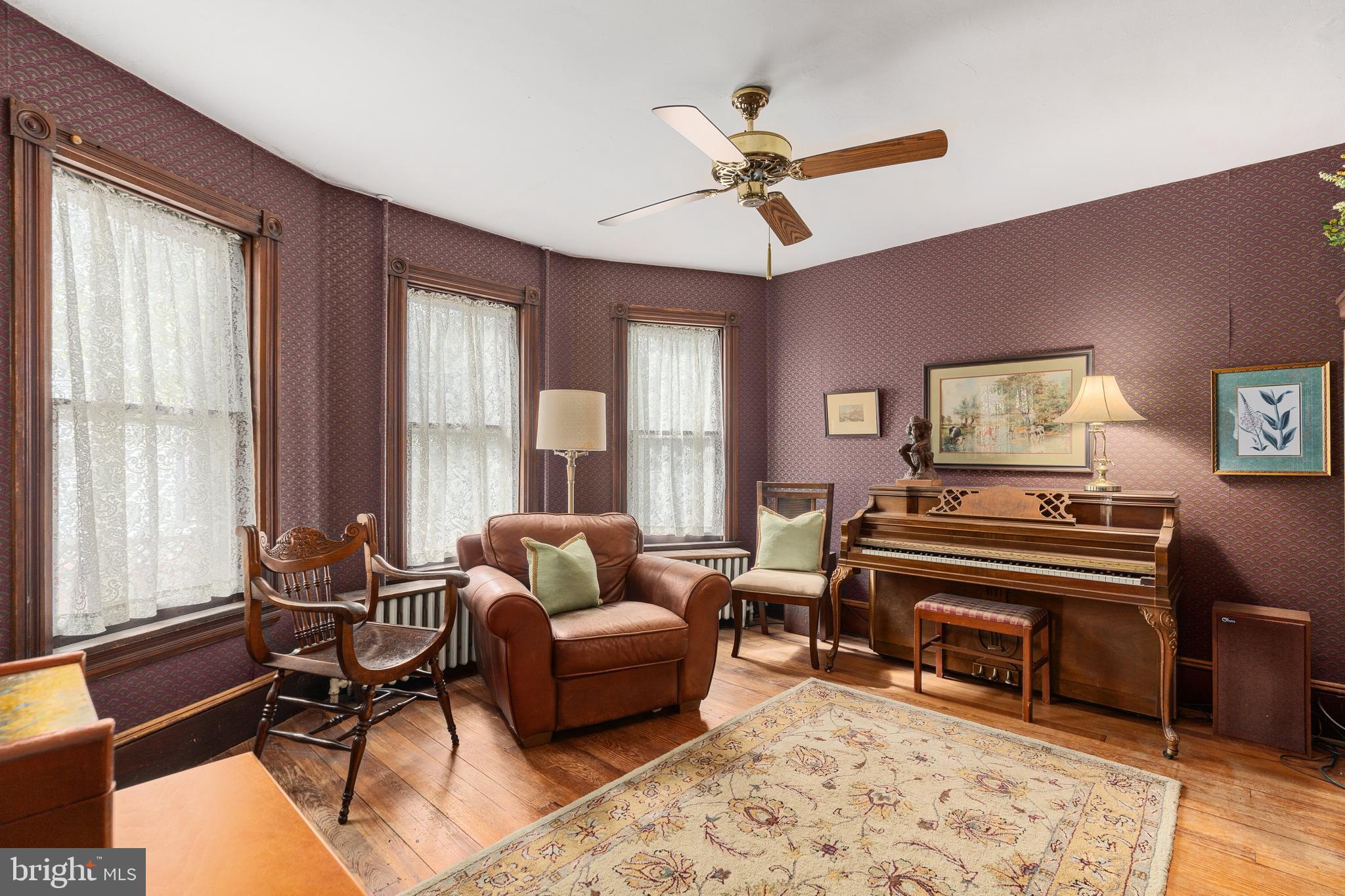 4140 Township Line Road Newtown, PA 18940 - Photo 20 of 41 a living room with furniture a piano and a large window