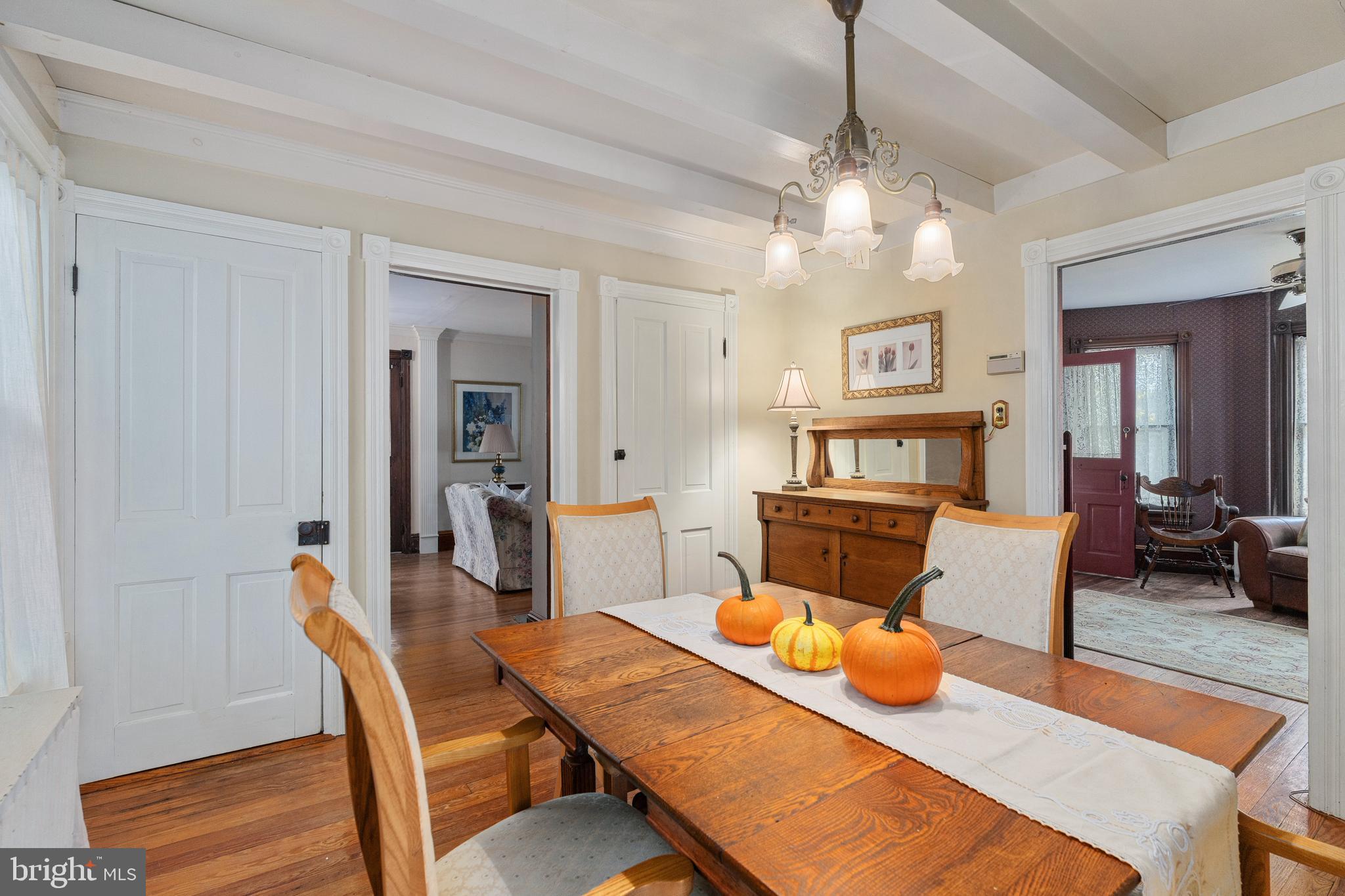4140 Township Line Road Newtown, PA 18940 - Photo 24 of 41 a view of a dining room with furniture a chandelier and wooden floor