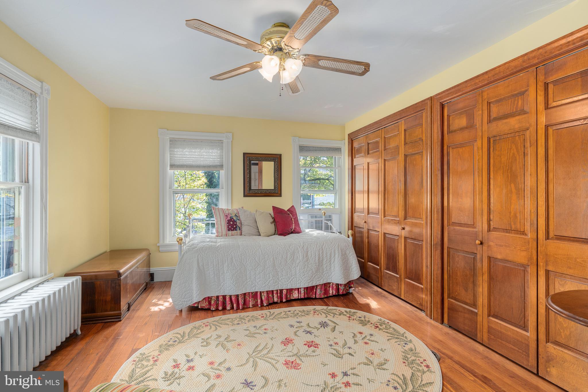 4140 Township Line Road Newtown, PA 18940 - Photo 35 of 41 a spacious bedroom with a bed and a chandelier