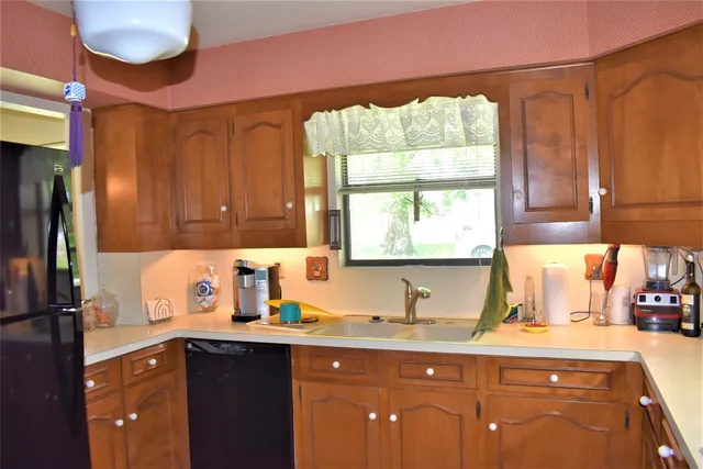 a kitchen with a sink cabinets and window