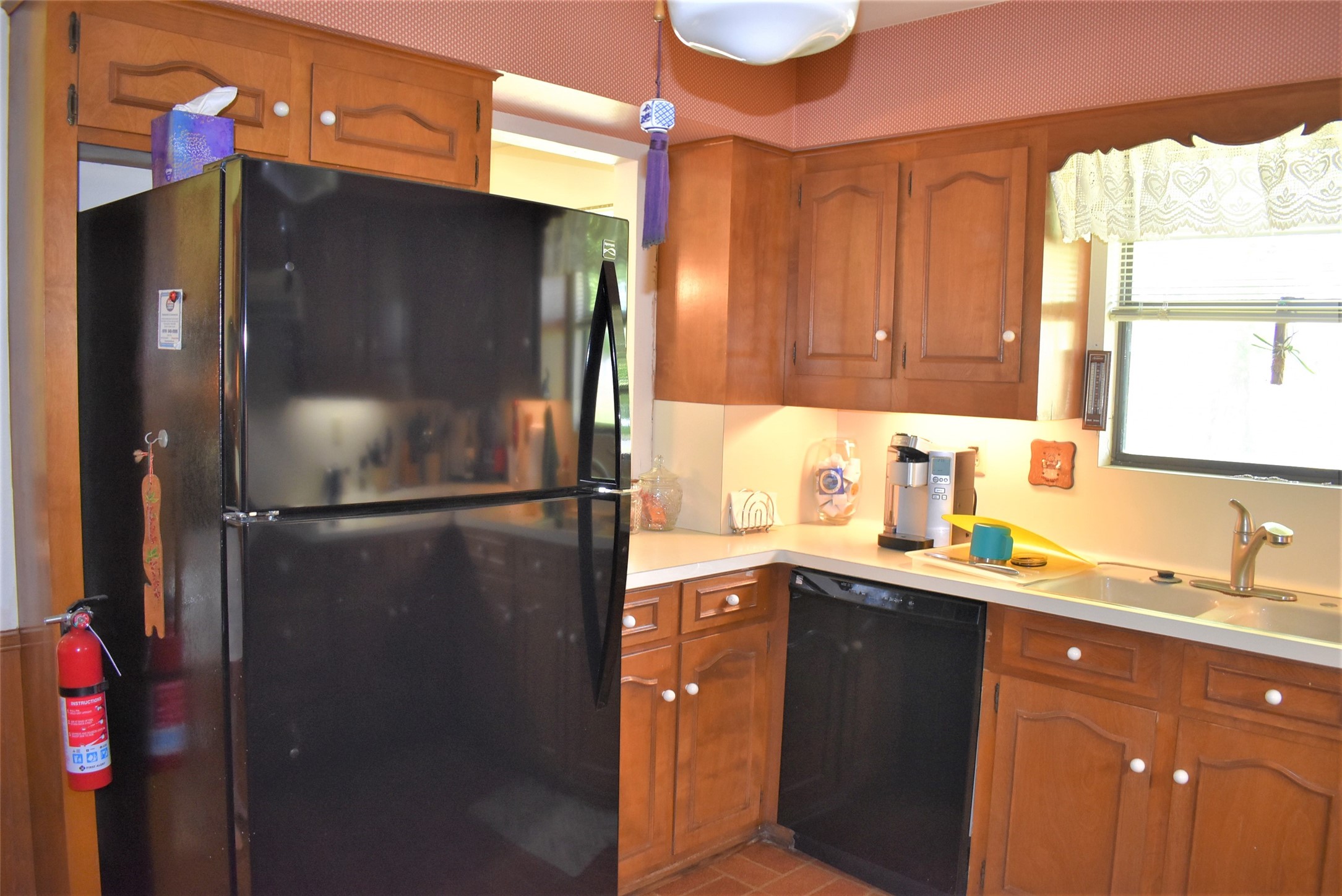 8854 FM 524 Road Sweeny, TX 77480 - Photo 13 of 45 a kitchen with a refrigerator and a sink