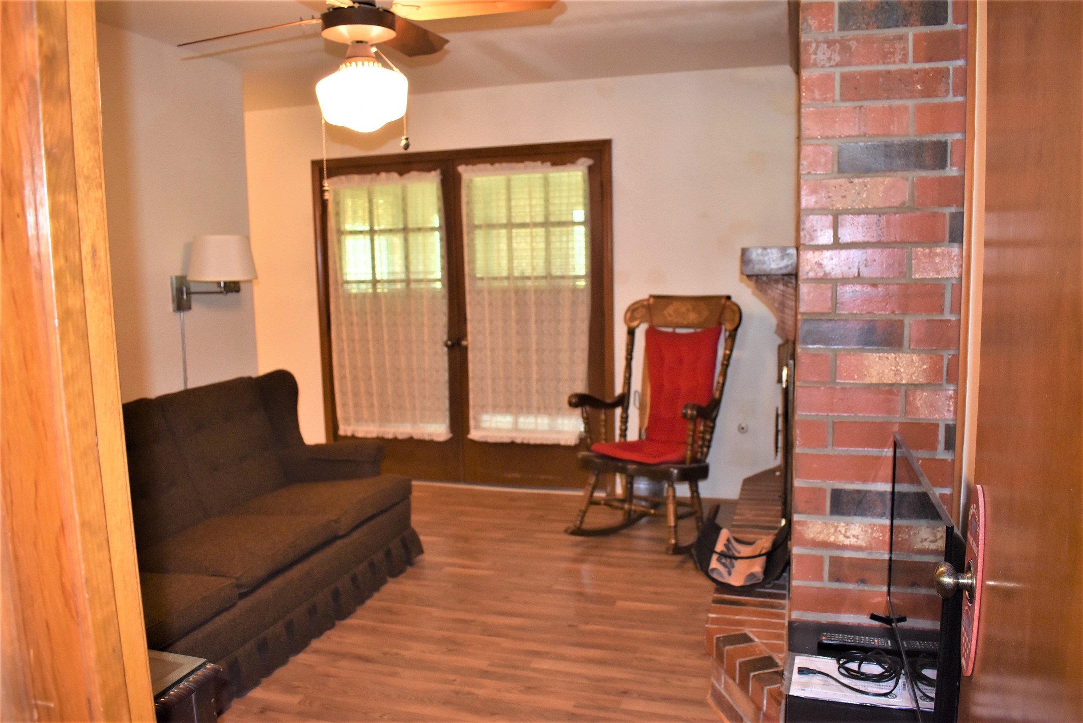 8854 FM 524 Road Sweeny, TX 77480 - Photo 14 of 45 a living room with furniture a wooden floor and a large window
