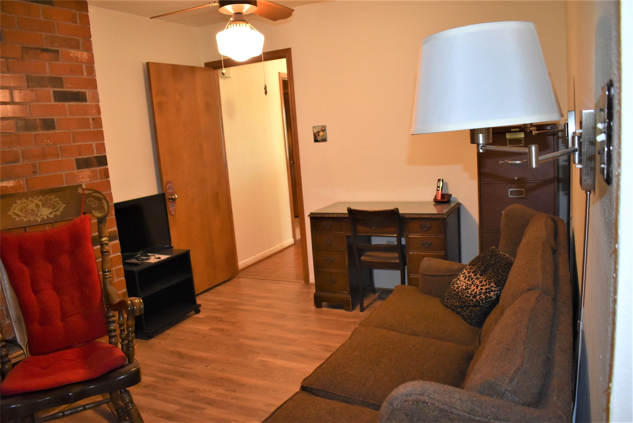 8854 FM 524 Road Sweeny, TX 77480 - Photo 16 of 45 a living room with furniture a lamp and a fireplace