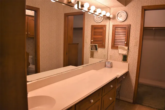 a bathroom with a sink a mirror and a shower