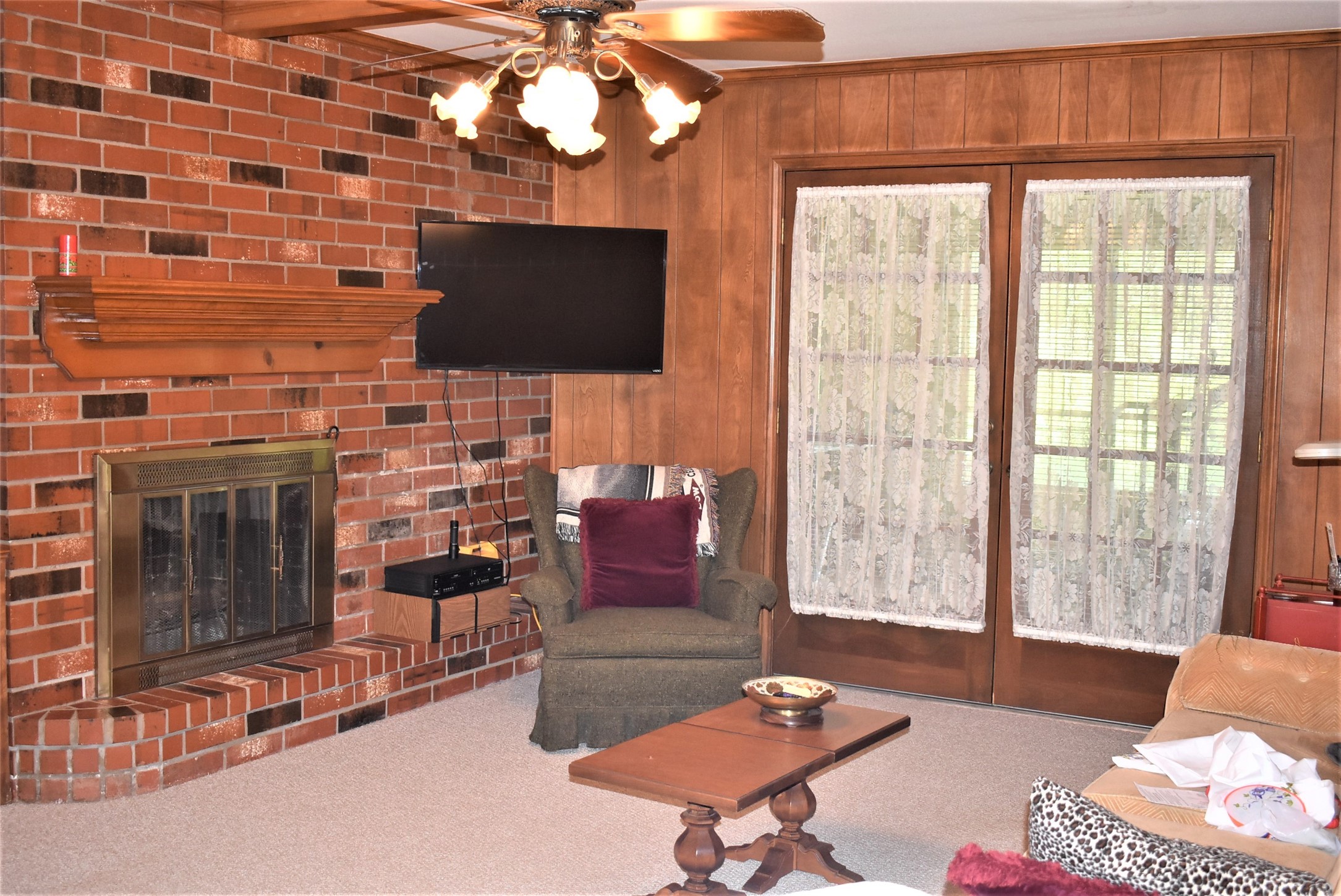 8854 FM 524 Road Sweeny, TX 77480 - Photo 32 of 45 a living room with furniture a flat screen tv and a fireplace
