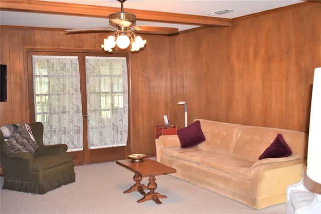 a living room with furniture and a chandelier