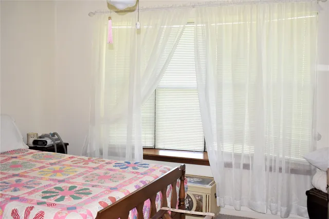 a bed sitting in a bedroom next to a window