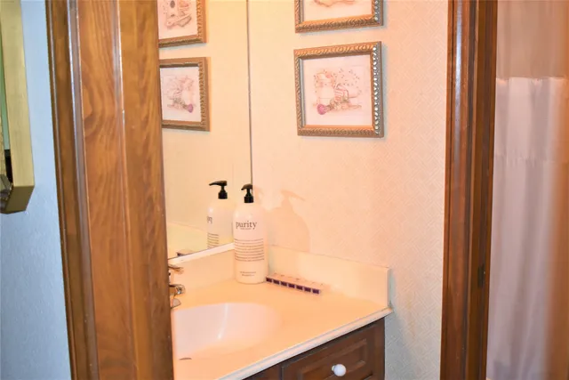 a view of a hallway with entryway wooden floor and front door