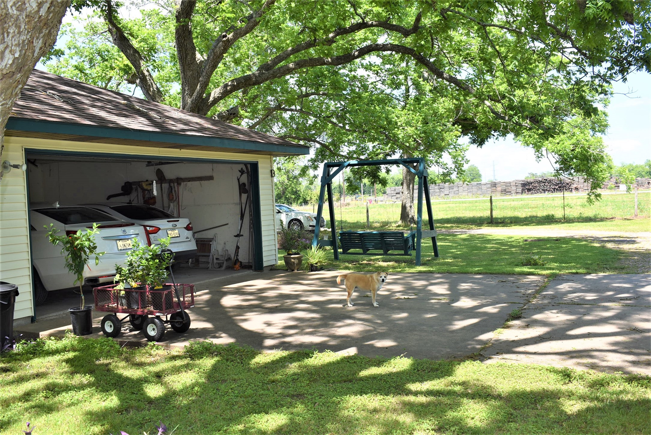 8854 FM 524 Road Sweeny, TX 77480 - Photo 5 of 45 a view of a patio with table and chairs potted plants and large tree