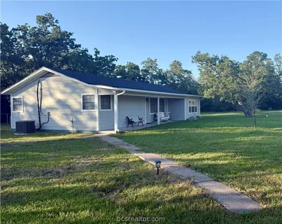 a view of a house with a back yard