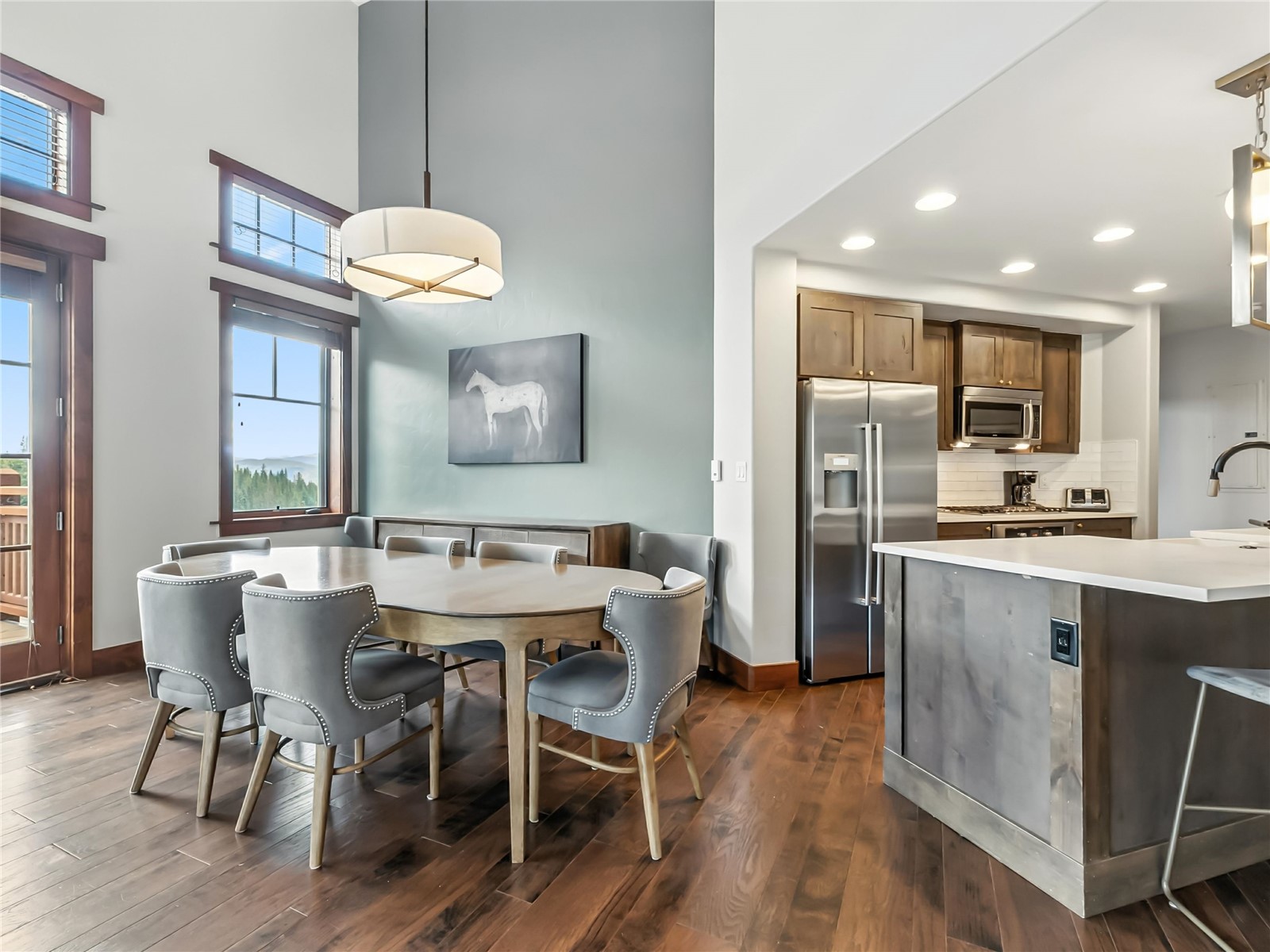 1521 Ski Hill Road, Unit 8424 Breckenridge, CO 80424 - Photo 11 of 41 a kitchen with a dining table chairs sink and wooden floor