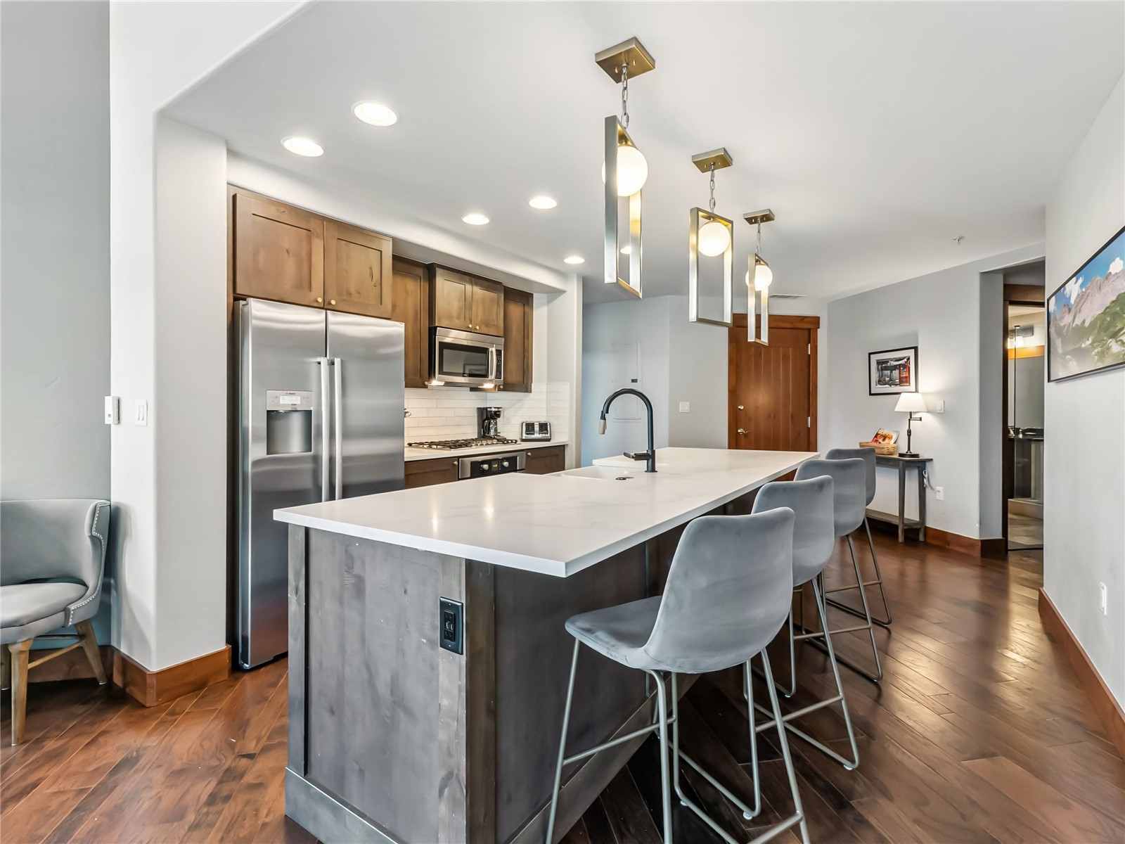 1521 Ski Hill Road, Unit 8424 Breckenridge, CO 80424 - Photo 13 of 41 a kitchen with stainless steel appliances a table chairs refrigerator and cabinets