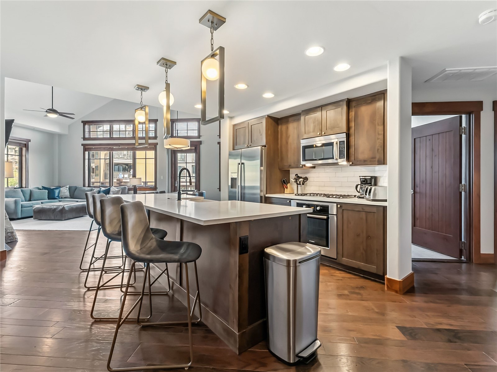 1521 Ski Hill Road, Unit 8424 Breckenridge, CO 80424 - Photo 17 of 41 a kitchen with stainless steel appliances granite countertop a stove top oven a sink dishwasher a dining table and chairs with wooden floor