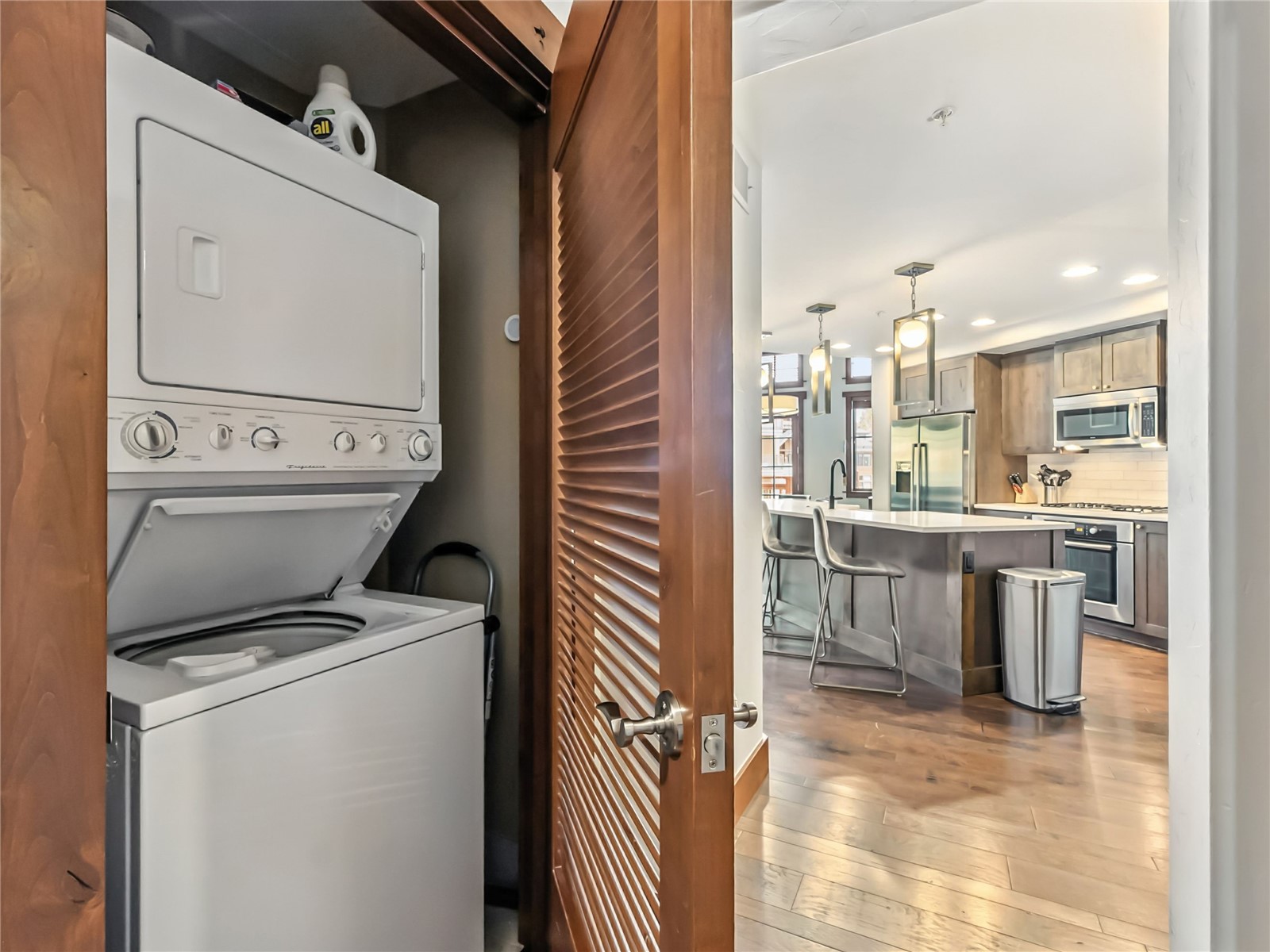 1521 Ski Hill Road, Unit 8424 Breckenridge, CO 80424 - Photo 32 of 41 a kitchen with a sink dishwasher and a refrigerator with wooden floor