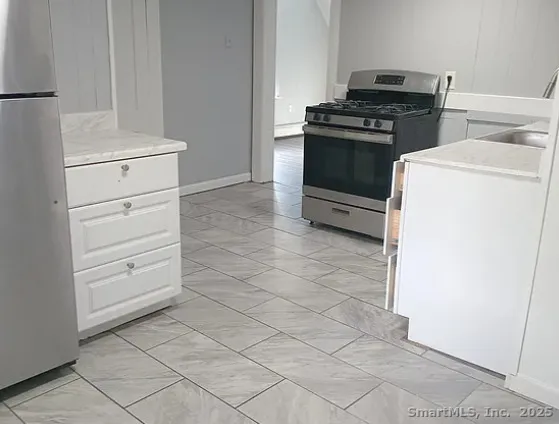 a kitchen with a stove and a refrigerator