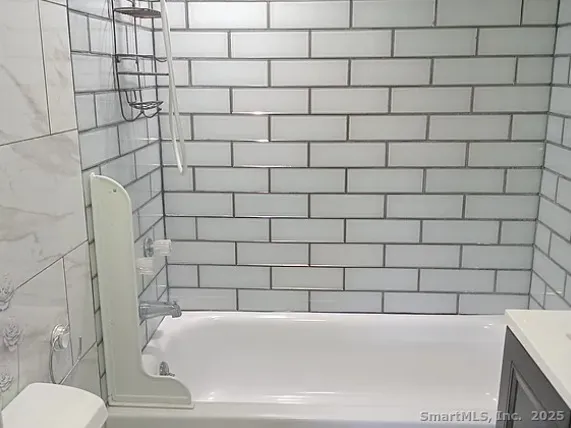 a bathroom with a bathtub and toilet