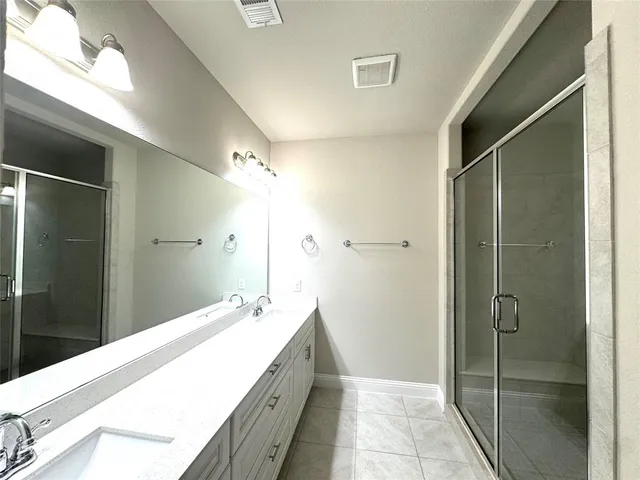 an empty room with a ceiling fan and carpet