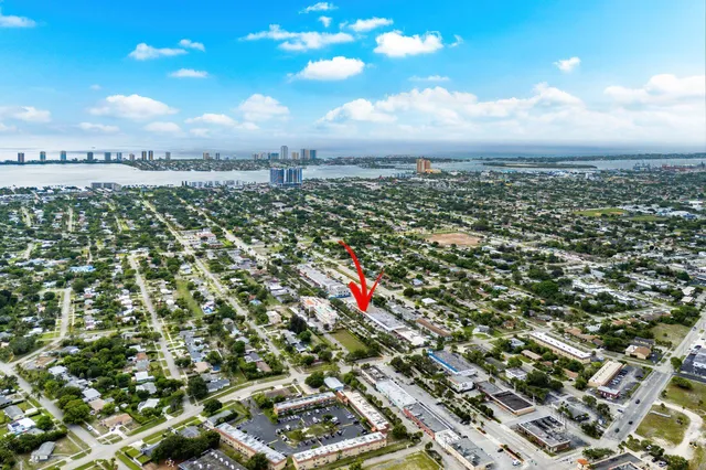 an aerial view of residential houses with outdoor space and parking