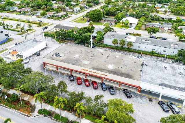 a view of building with car parked