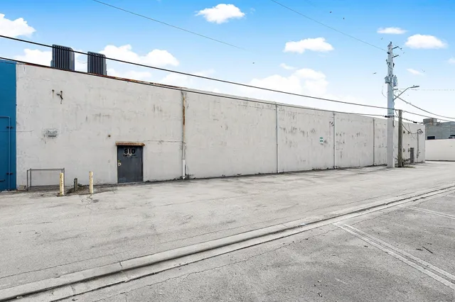 an aerial view of residential houses with outdoor space and lake view