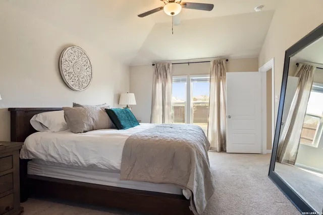 a bedroom with a large bed and a large window