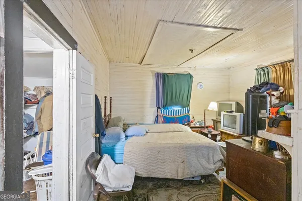 a bedroom with bed and glass door