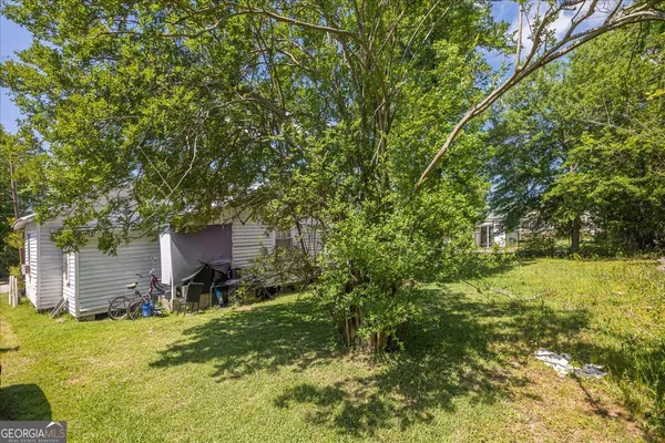 a backyard of a house with table and chairs