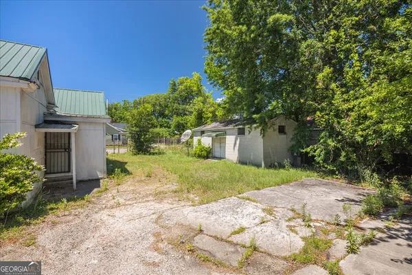 a view of a house with a yard and tree s