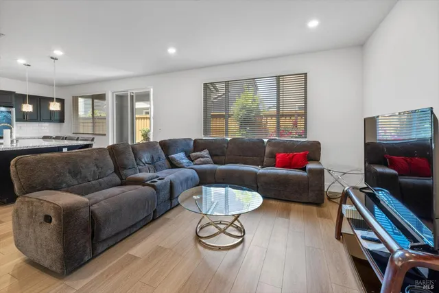 a large kitchen with a table and chairs