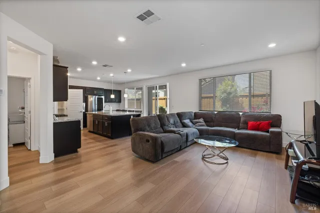 a large kitchen with stainless steel appliances granite countertop a sink stove and refrigerator
