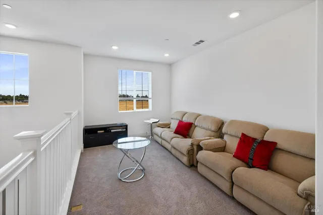 a bedroom with a bed and a flat tv screen on dresser