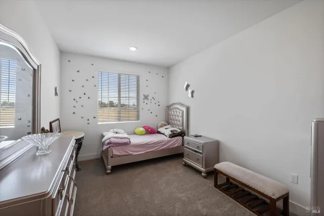 a bedroom with a bed and a dresser