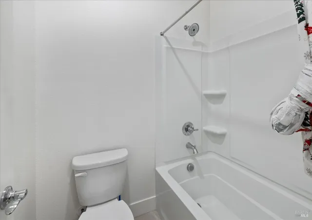 a spacious bathroom with a bathtub shower sink double and mirror