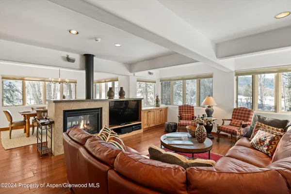 a living room with furniture fireplace and flat screen tv