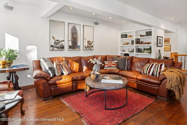 a living room with furniture a rug and a window