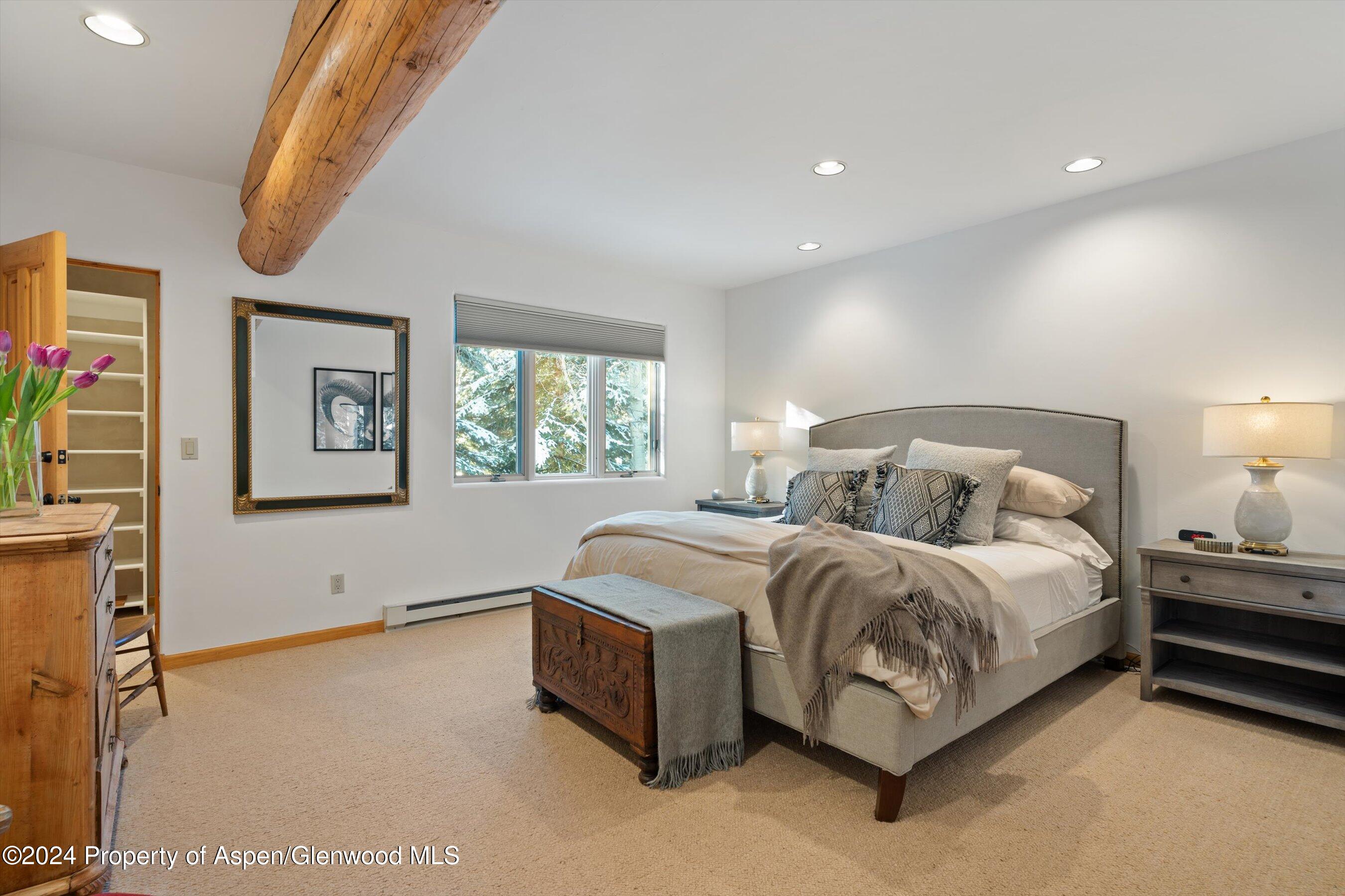 825 Cemetery Lane, Unit 2 Aspen, CO 81611 - Photo 20 of 47 a spacious bedroom with a bed and a large window
