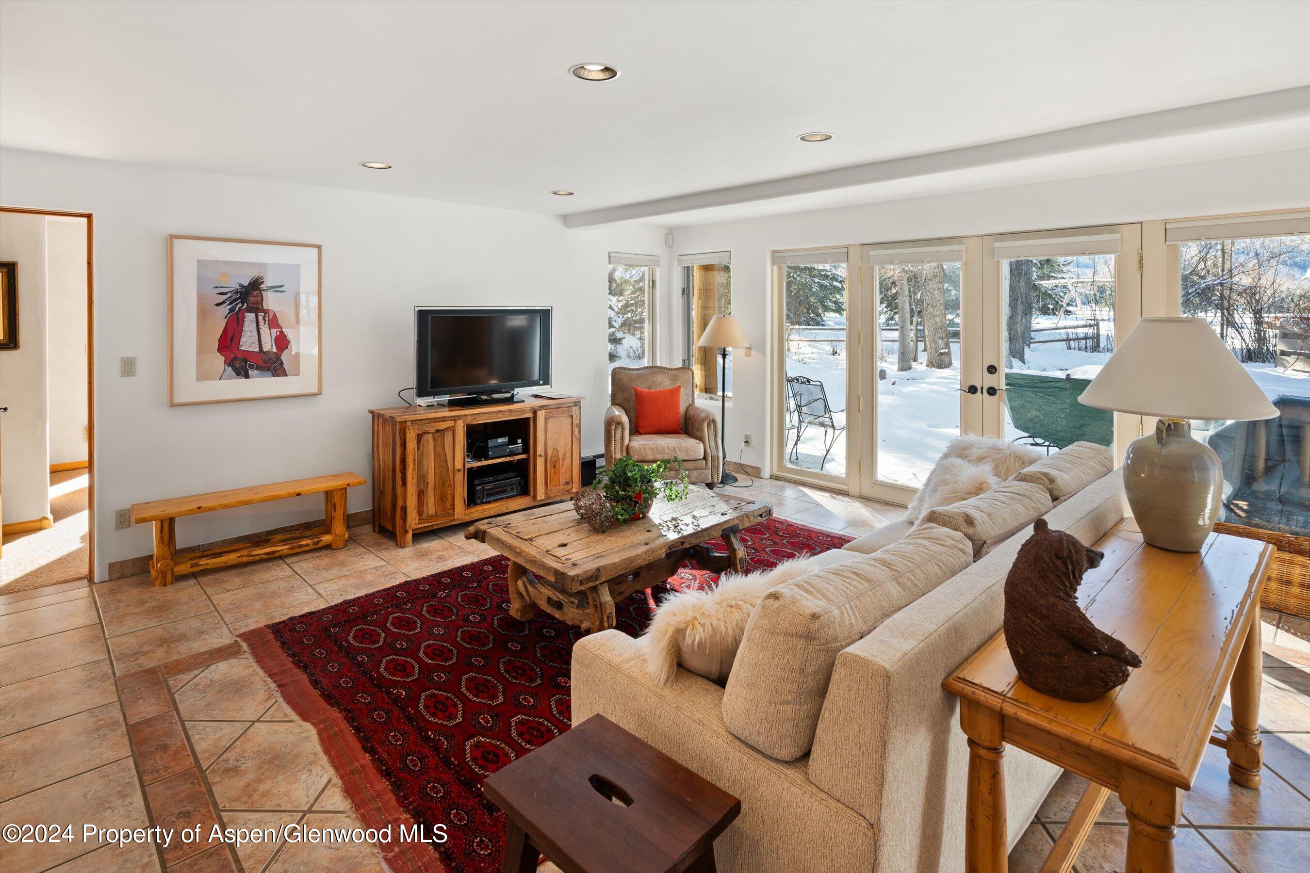 825 Cemetery Lane, Unit 2 Aspen, CO 81611 - Photo 35 of 47 a living room with furniture and a flat screen tv