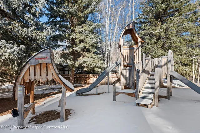 a living room with a couch and a dresser next to a window
